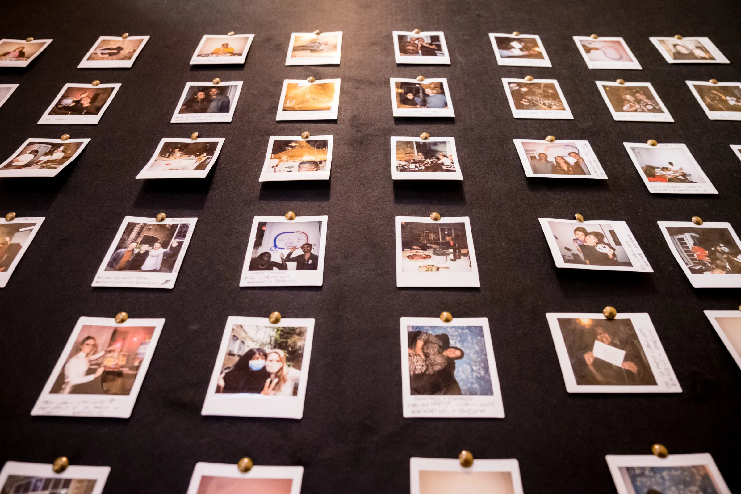 Backed VC - Wall of pinned Polaroids from AGMs and portfolio gatherings