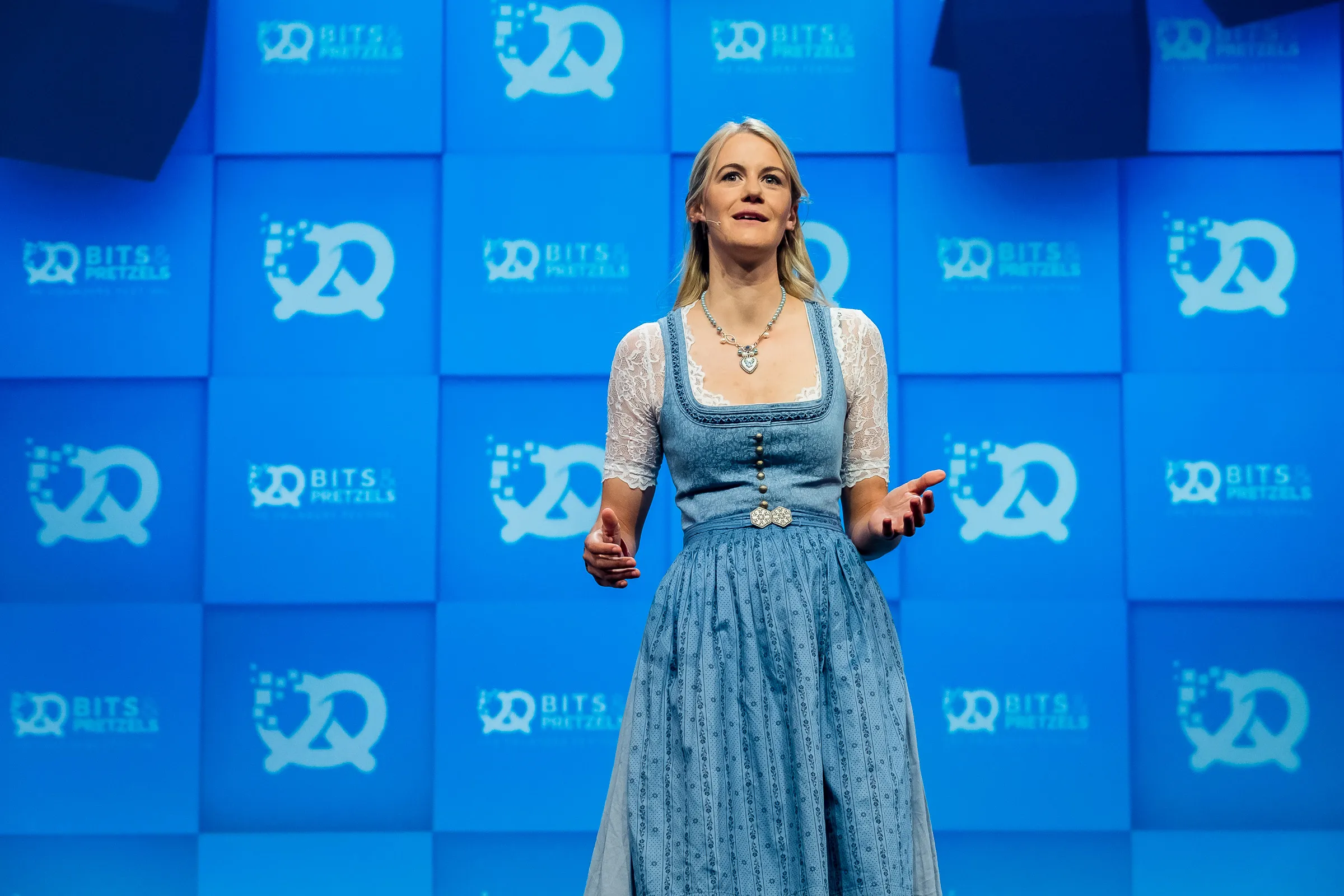 Bits & Pretzels 2019 - Speaker in traditional Bavarian dirndl addressing the stage