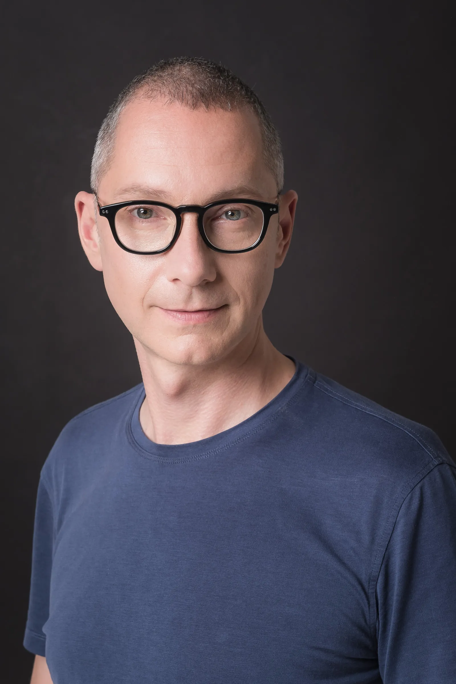 Borys Lozhkin Headshots - Casual portrait with glasses, dark backdrop