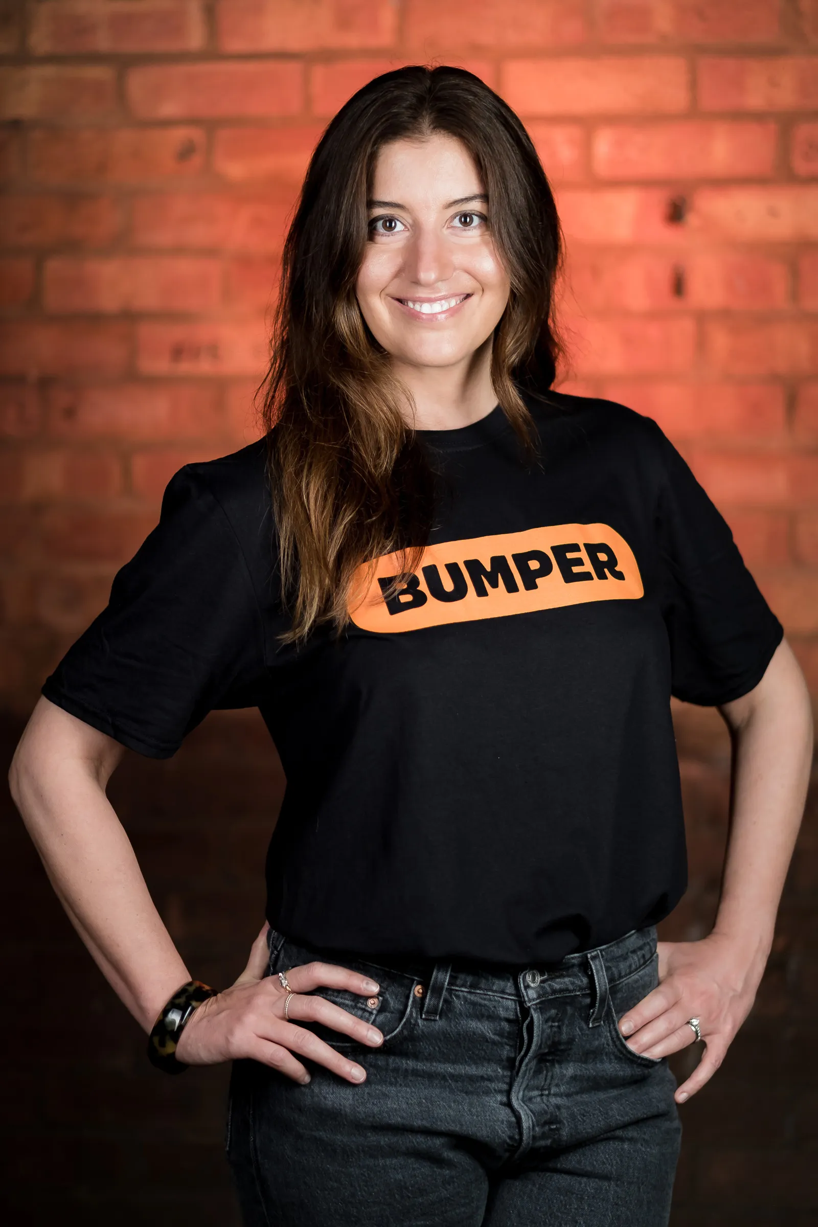 Bumper Team Photography - Three-quarter portrait, branded Bumper t-shirt, exposed brick backdrop