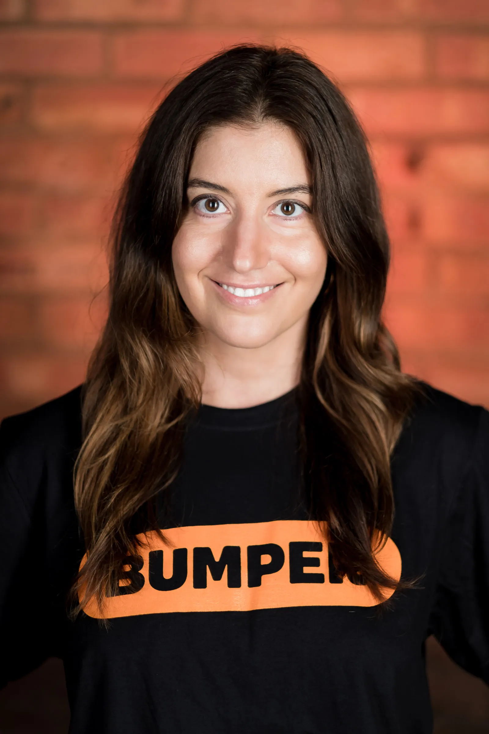 Bumper Team Photography - Individual headshot, branded Bumper t-shirt, exposed brick backdrop