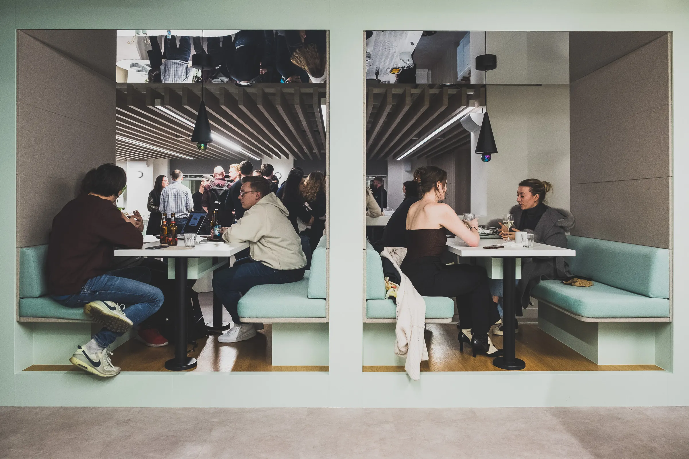 FOV Ventures First Birthday Party - Guests seated in booths, candid conversation