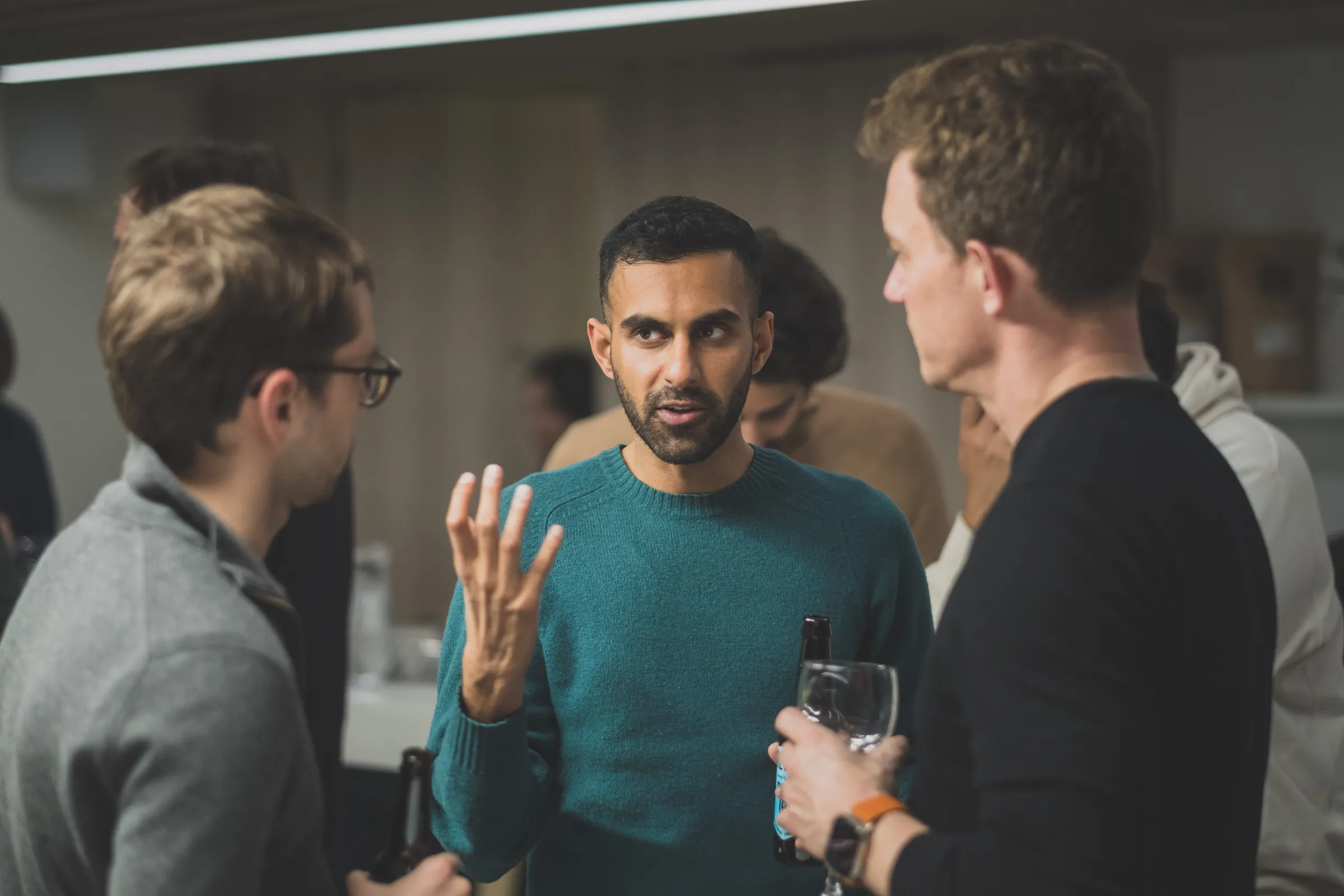 FOV Ventures First Birthday Party - Animated conversation between three guests
