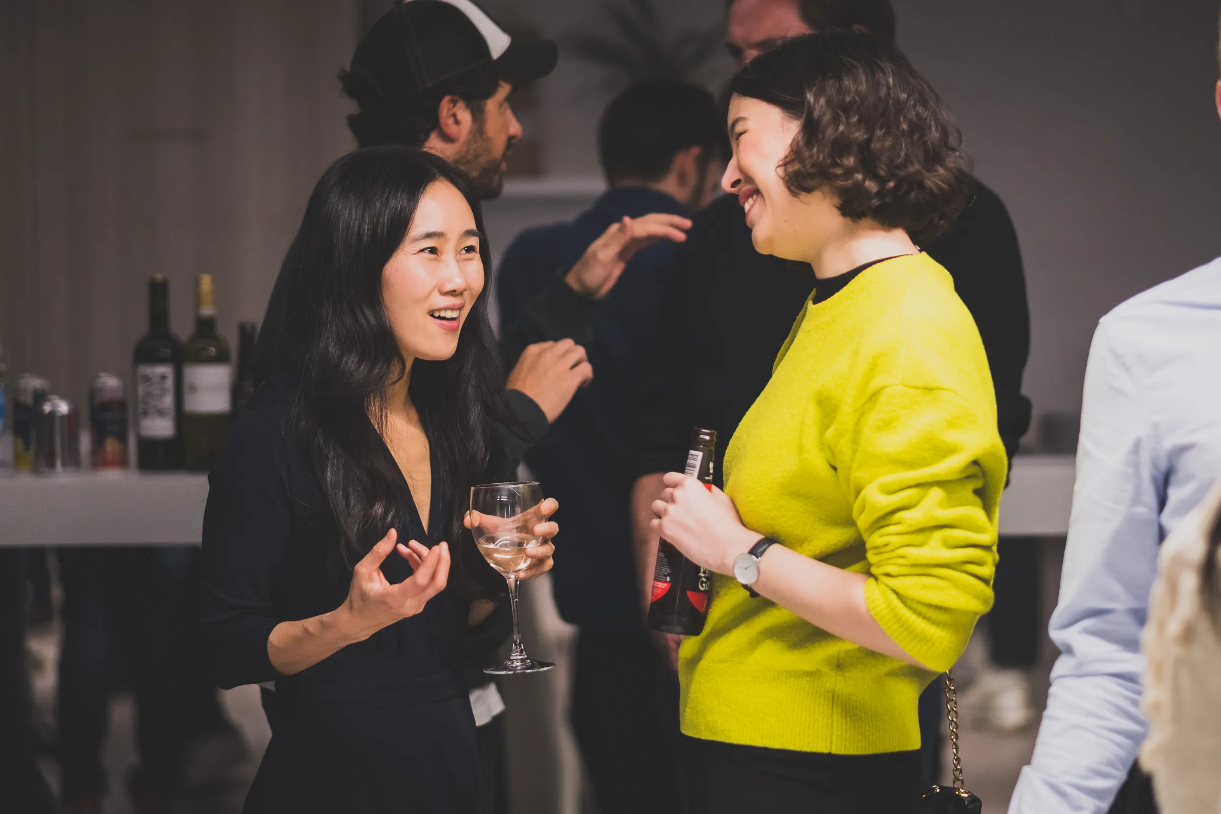 FOV Ventures First Birthday Party - Two guests laughing over wine