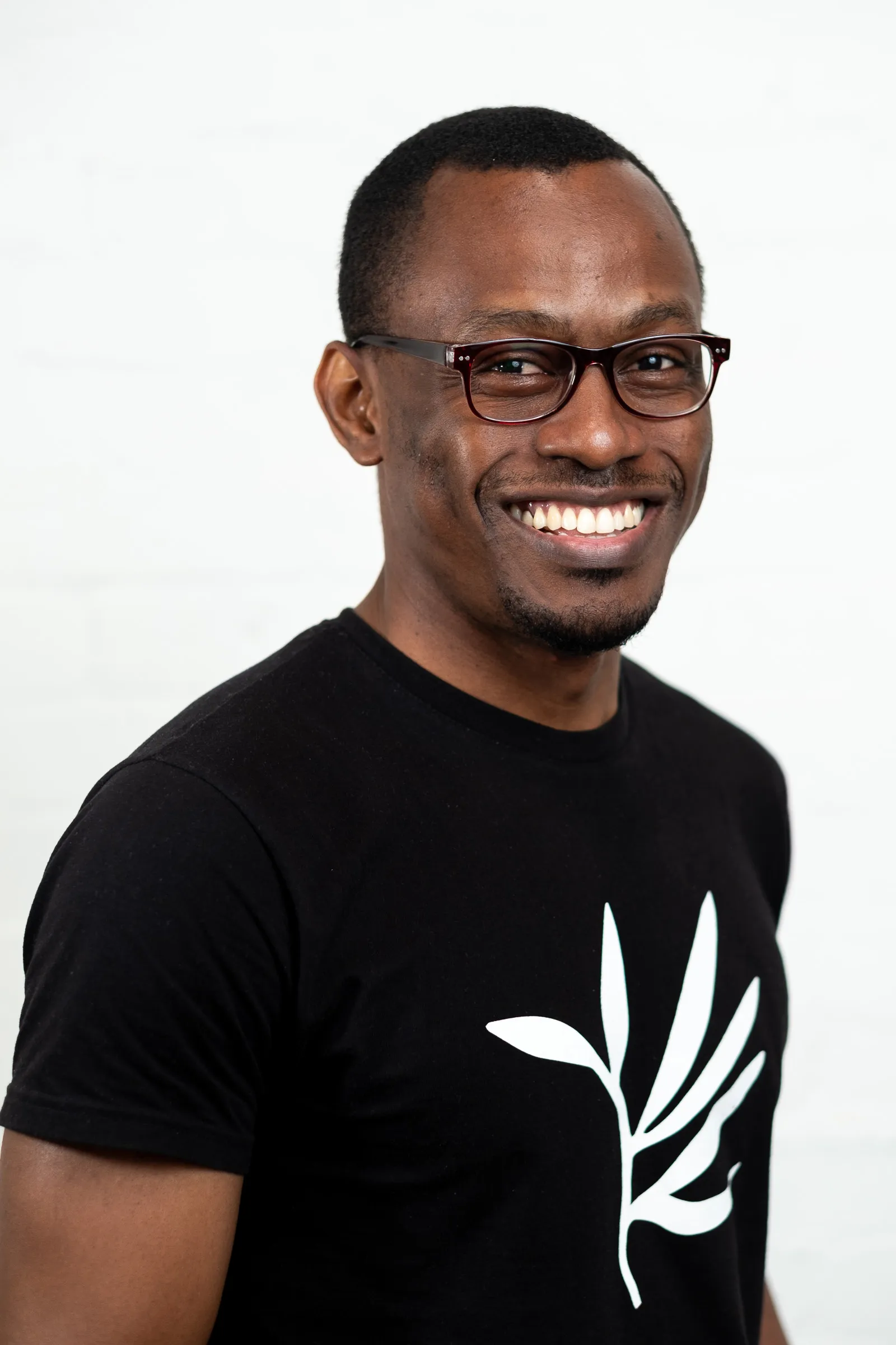 Infarm London Team Photography - Studio headshot, branded Infarm leaf t-shirt, glasses