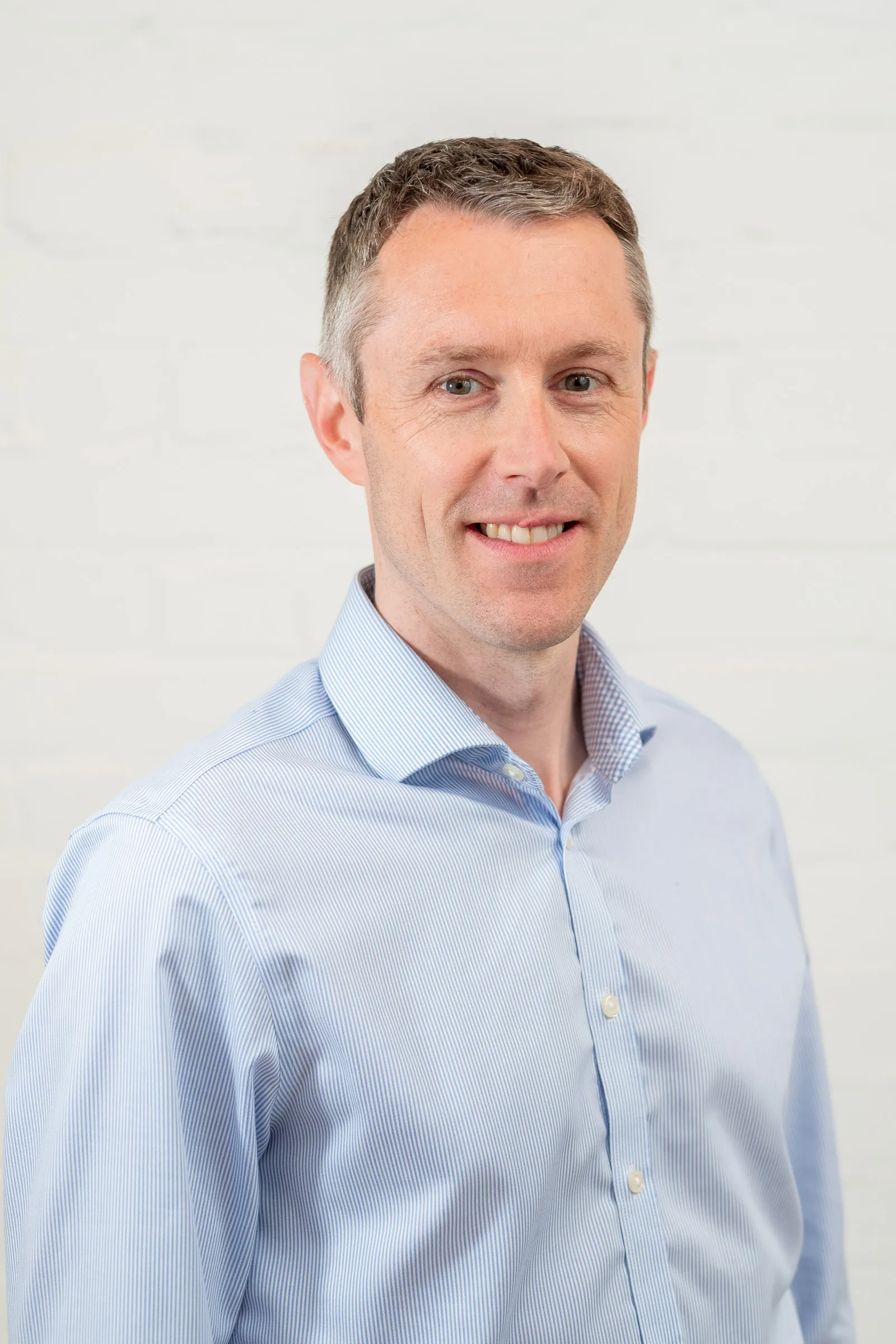 Infarm London Team Photography - Studio headshot, white backdrop, blue shirt