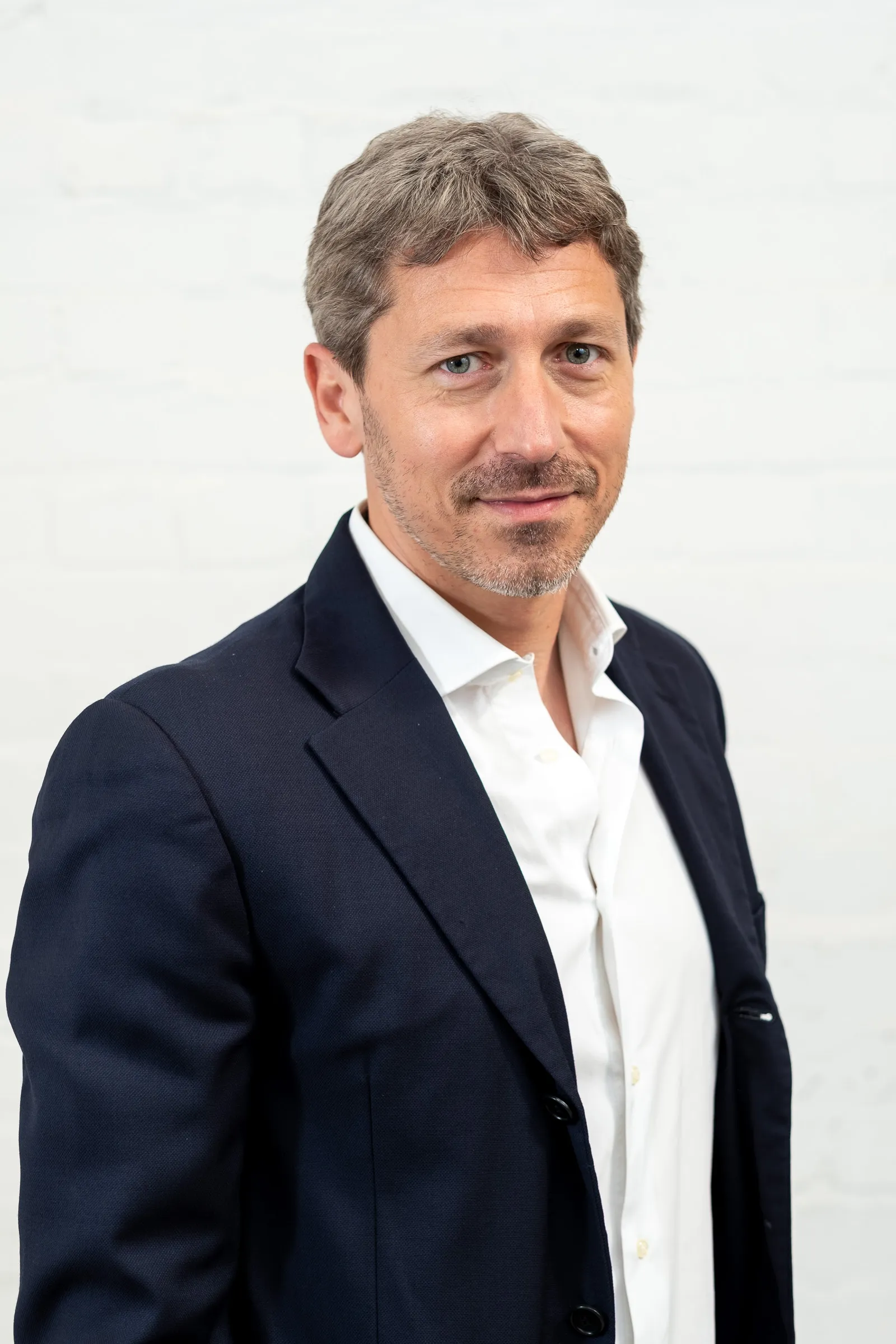 Infarm London Team Photography - Studio headshot, white backdrop, navy blazer
