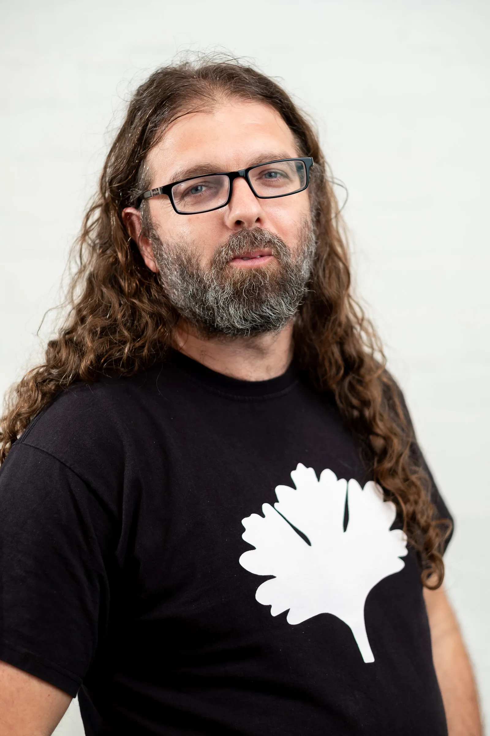 Infarm London Team Photography - Studio headshot, branded Infarm leaf t-shirt, glasses