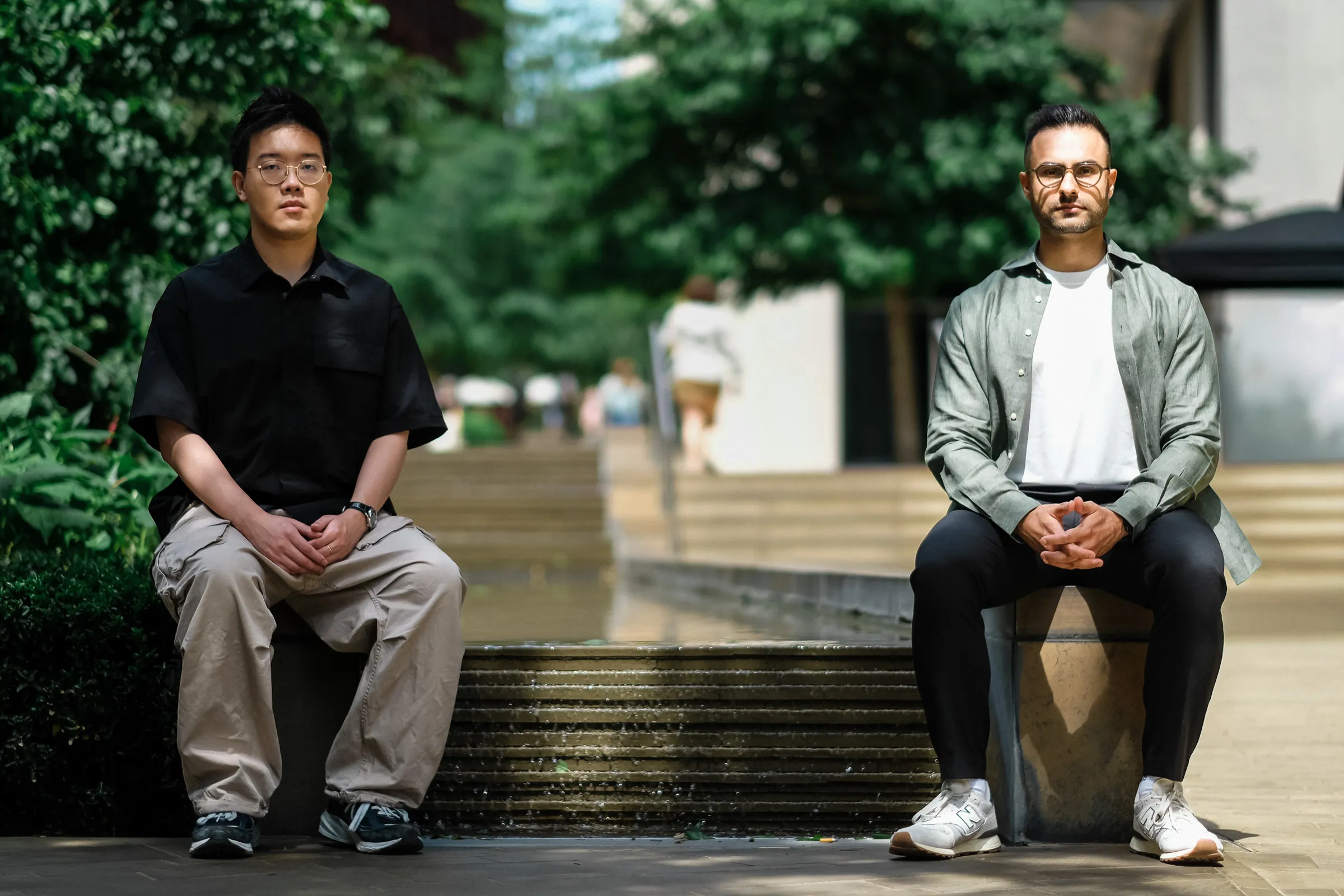 Zaro.ai Founder Portraits - Founders seated apart at Two Pancras Square fountain