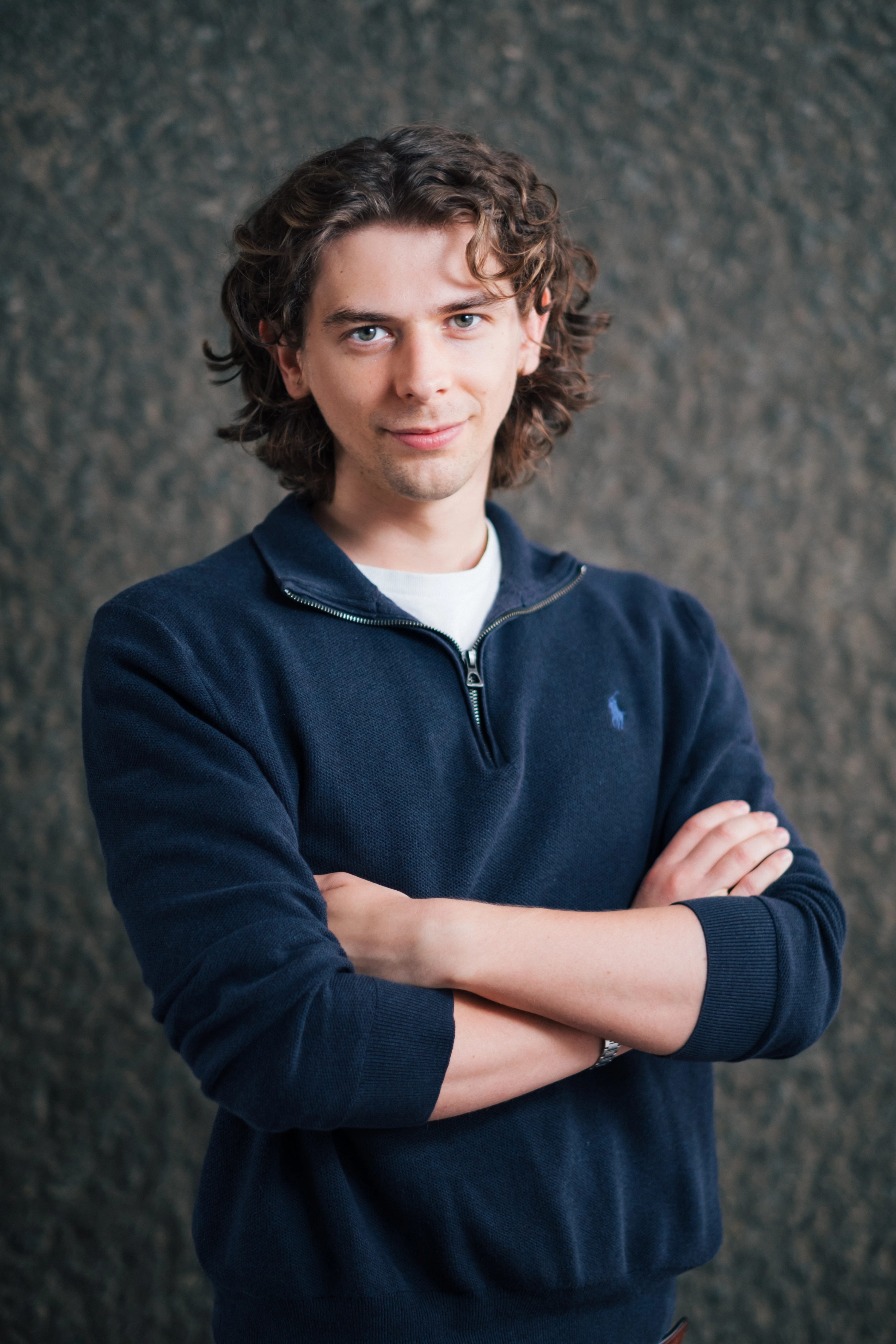 Zenithon AI Founders - Portrait of Alex Higginbottom, founder and CEO, against textured concrete